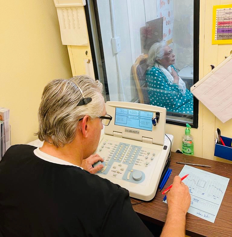 Audiologist conducting hearing test